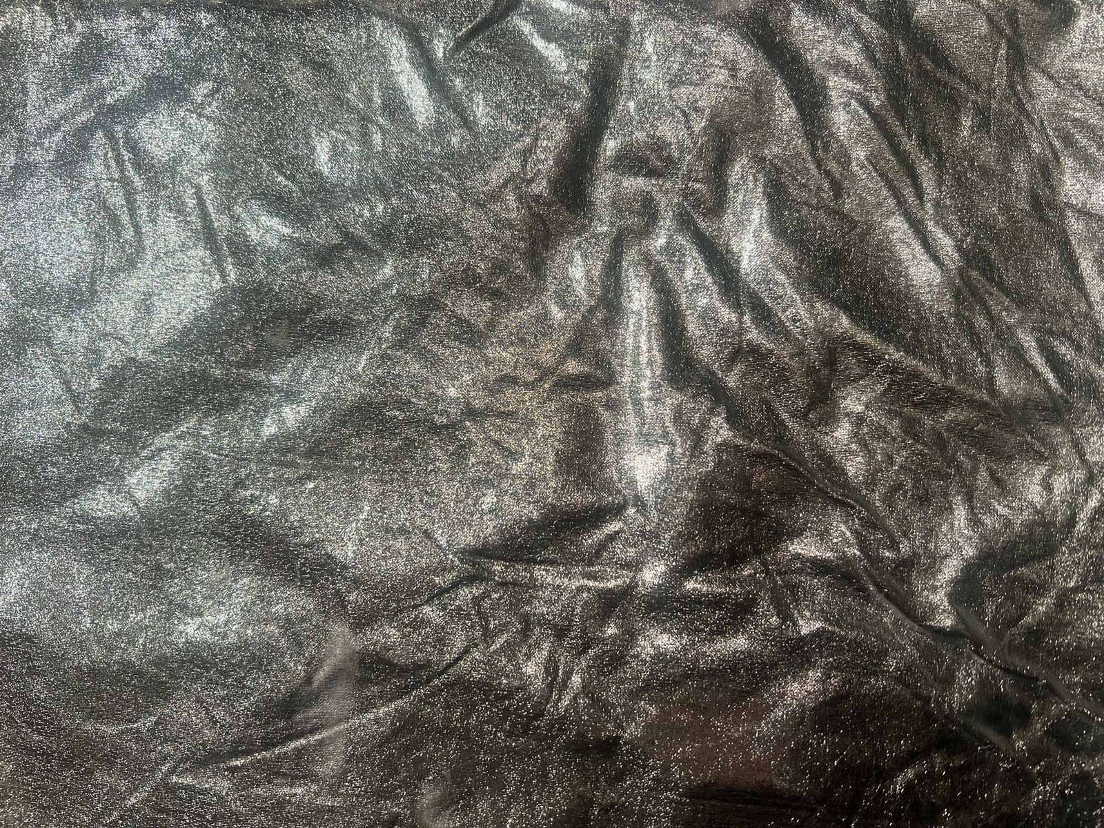 Photo of the silver surface. This is the fabric that Nastya and Kira used to line up their stim objects in photos and videos for "Stim Sharing Guide". There are many folds on the right side. On the left side, light falls on the fabric. It glitters. That's why Kira and Nastia chose this fabric.