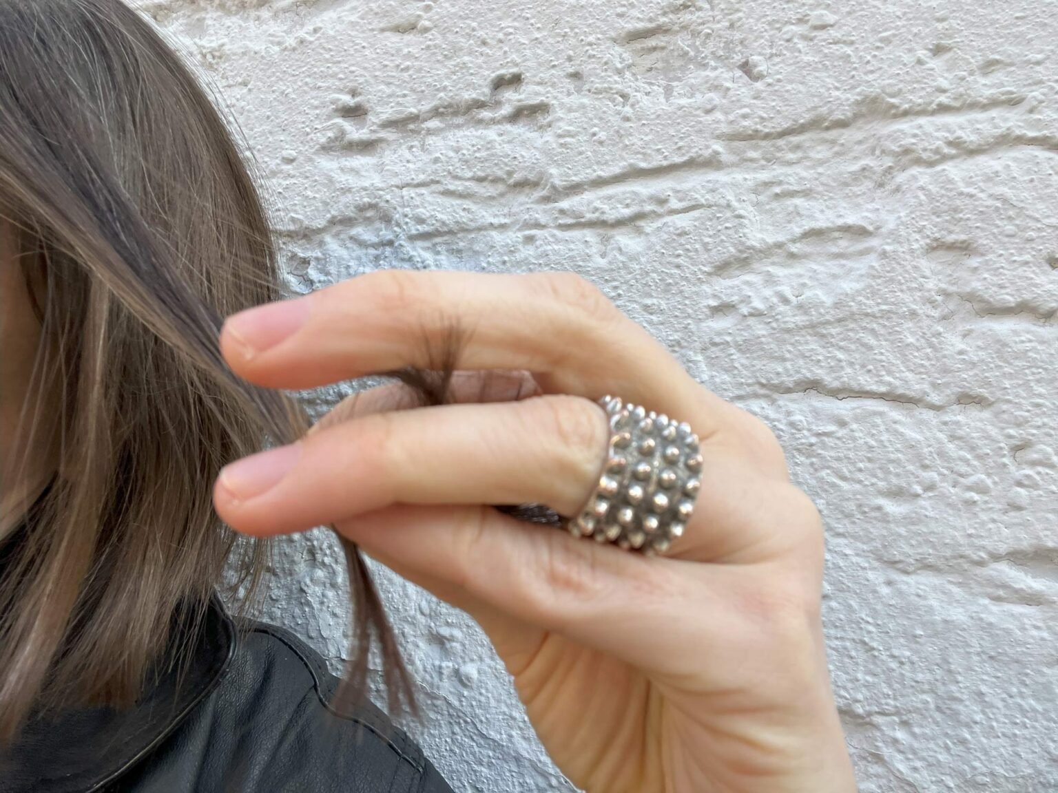 My hair is currently long up to my chin. It's light brown with silver streaks. I tried to capture my favourite moment in this photo. I took a strand of hair and pulled it to the right side. My middle finger touches the ends of this strand of hair many times. I like it. The hair ends are soft and at the same time, they slightly tingle on my finger. It makes a sound that reminds me of the rustling of a hedgehog or autumn leaves. It's just more quiet and softer. It sometimes helps me not to think, because my head is often overflowing with parallel thoughts, and voices. I like soft and prickly textures at the same time when they alternate each other. They help me to feel and search my body.